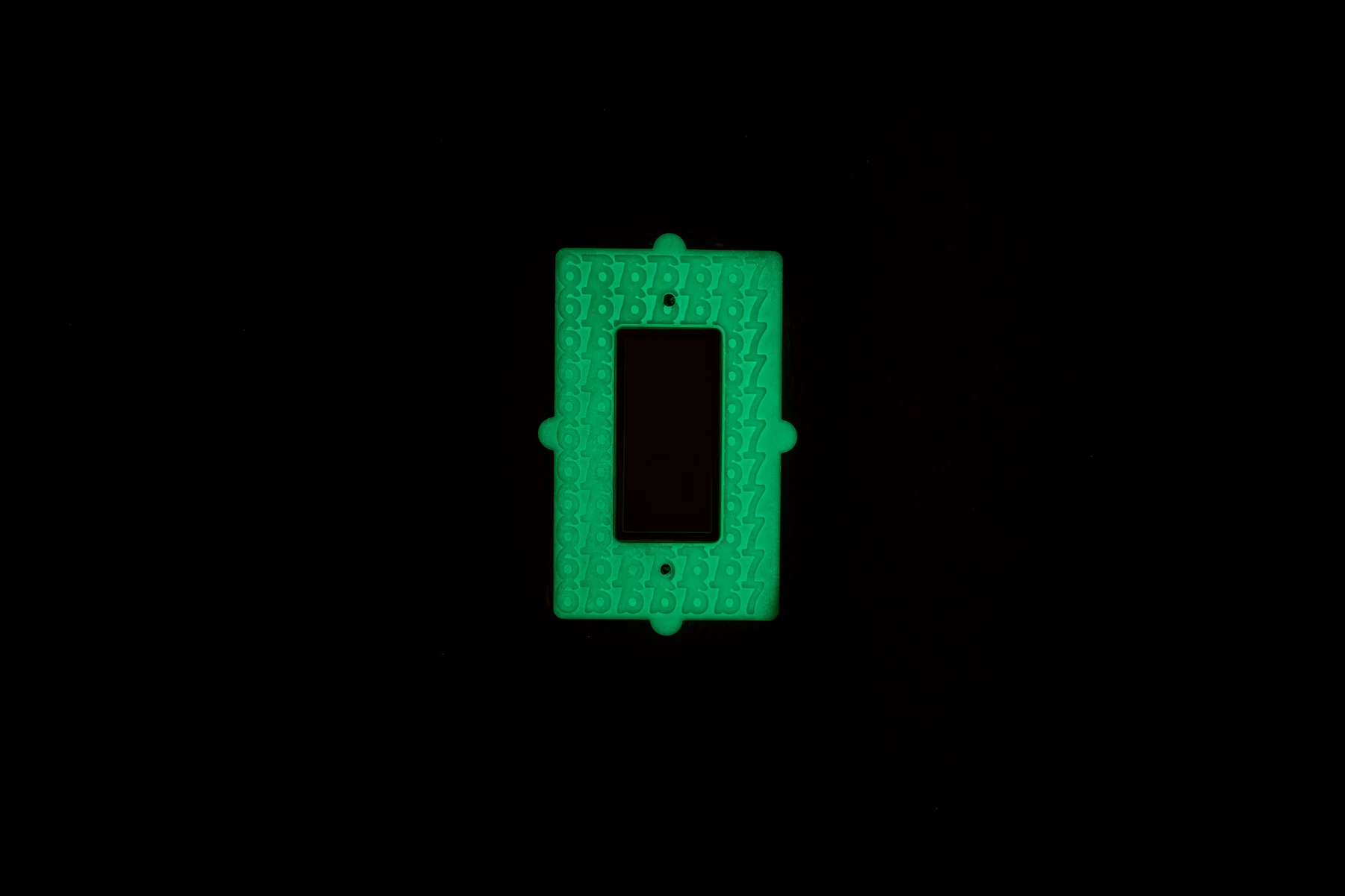 Close-up view of the glowing NightBloom Prime switch plate